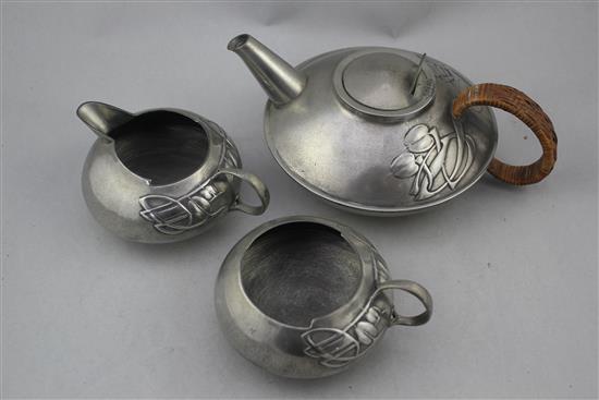 A Liberty Tudric pewter three piece tea set, no.0231, designed by Archibald Knox, teapot 9.75in.